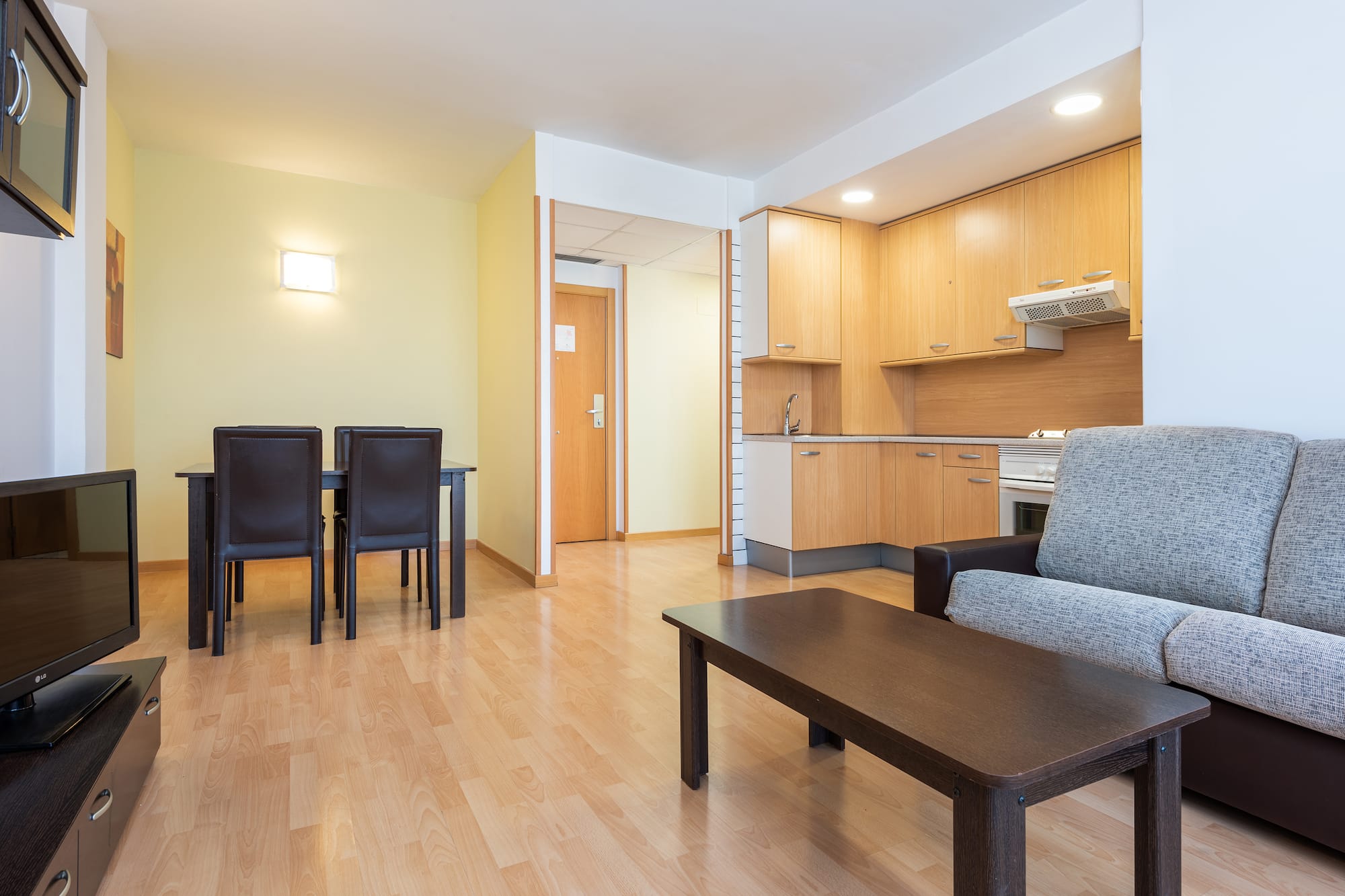 a living room with a table and chairs