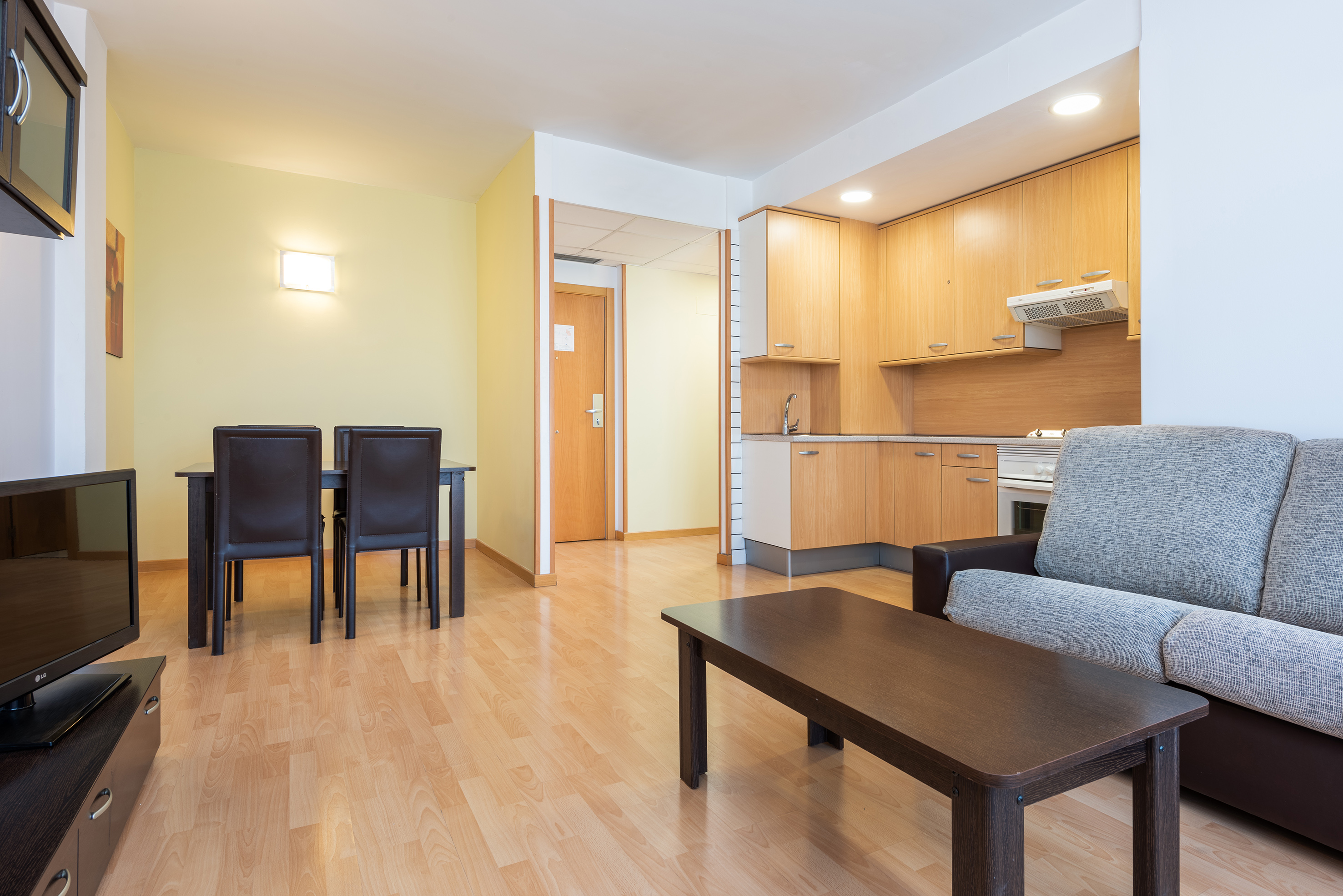 a living room with a table and chairs