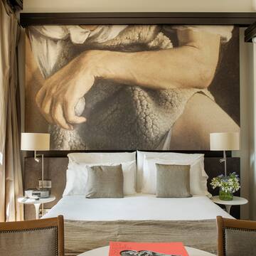 a bed with a large picture above it