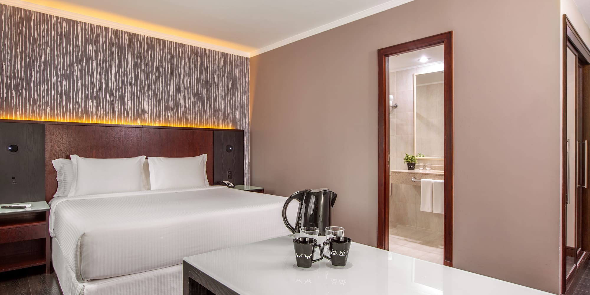 a room with a bed and a coffee pot