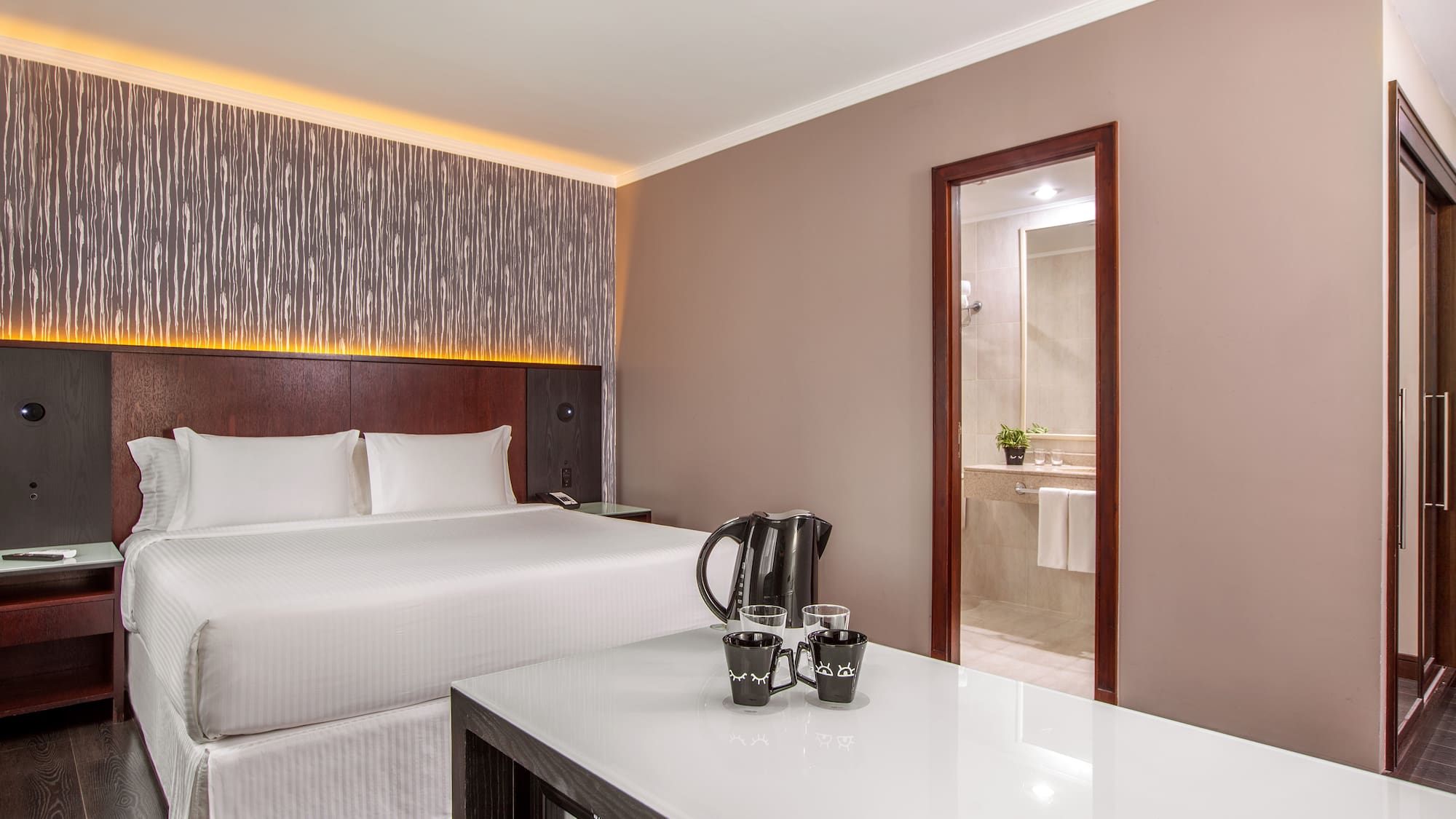 a room with a bed and a coffee pot