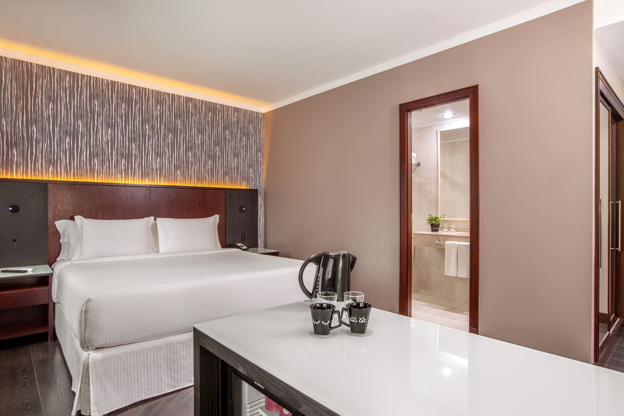 a room with a bed and a coffee pot