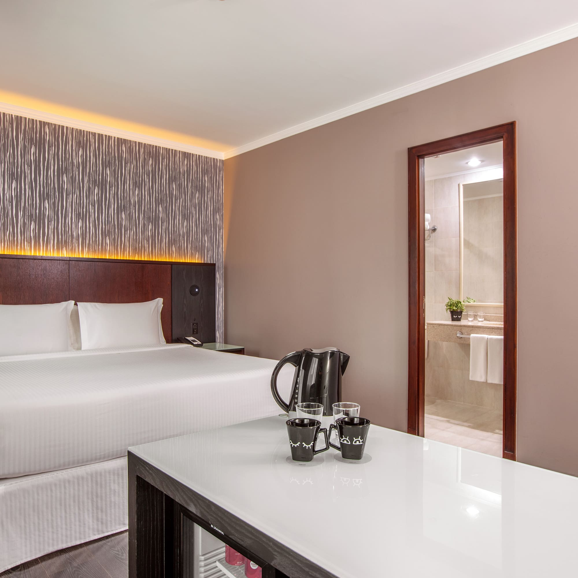 a room with a bed and a coffee pot