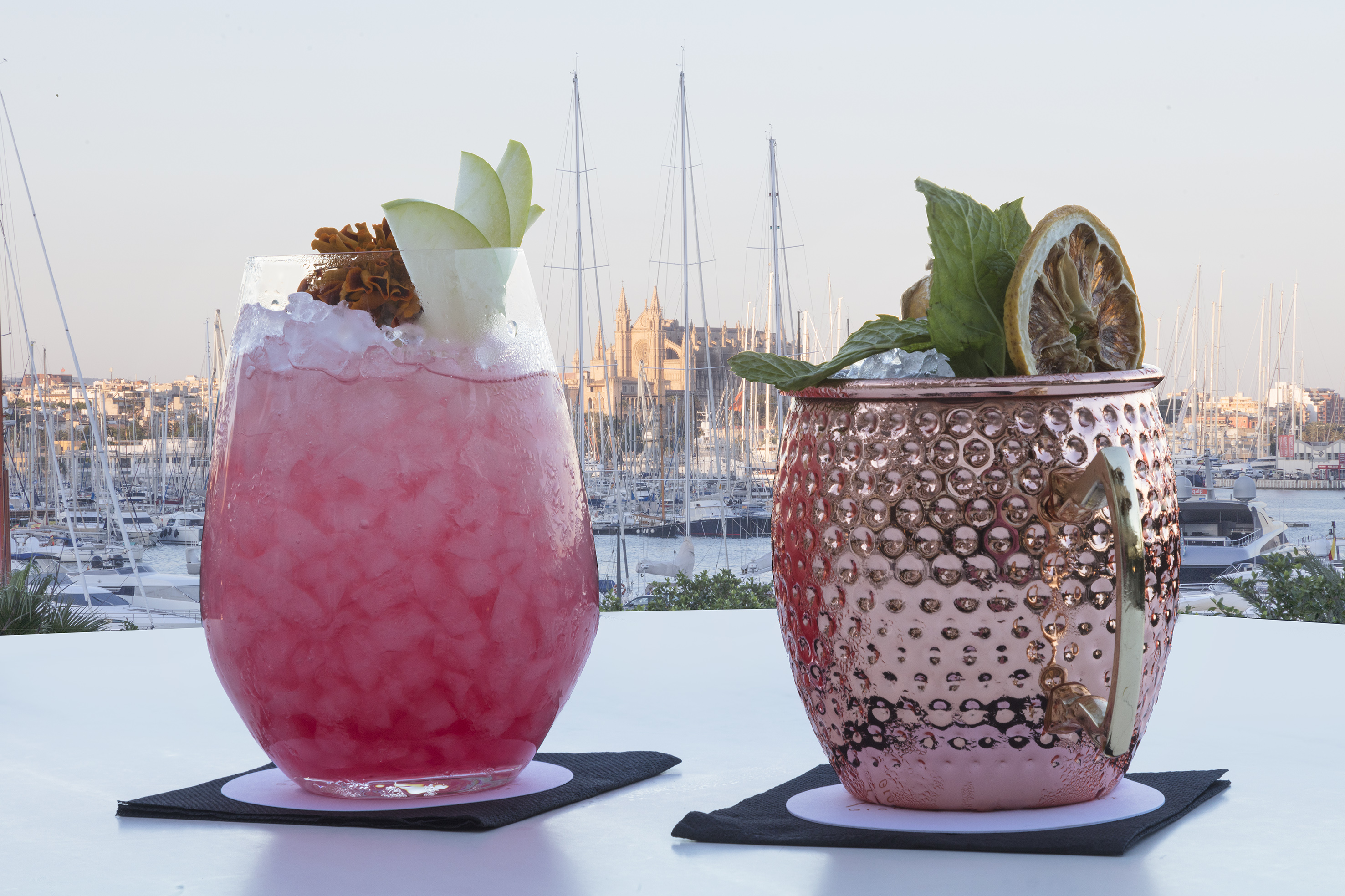 Cocktails overlooking Palma marina with cathedral and sailboats.