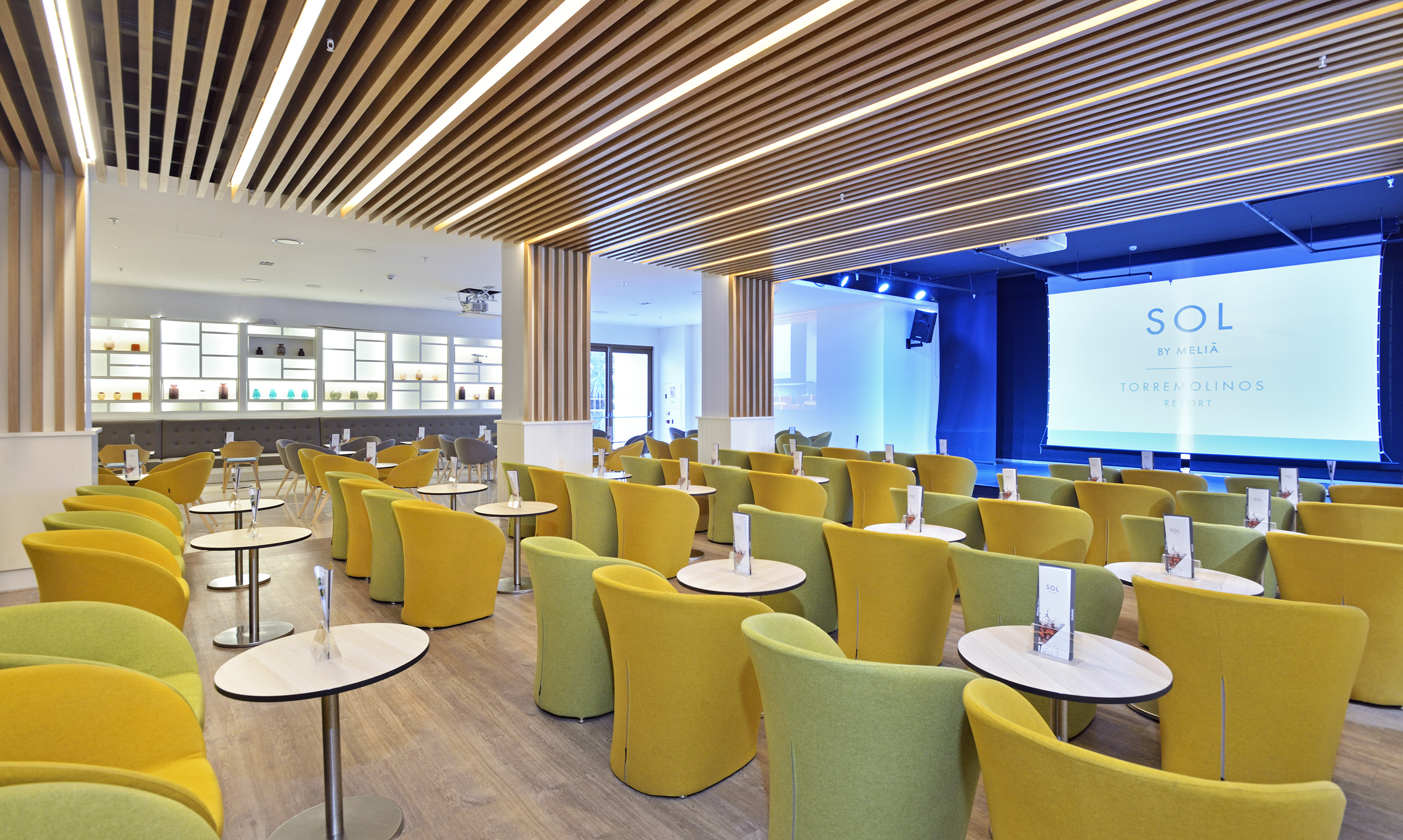 Sol Meliã Torremolinos conference room with modern chairs, tables, and screen.