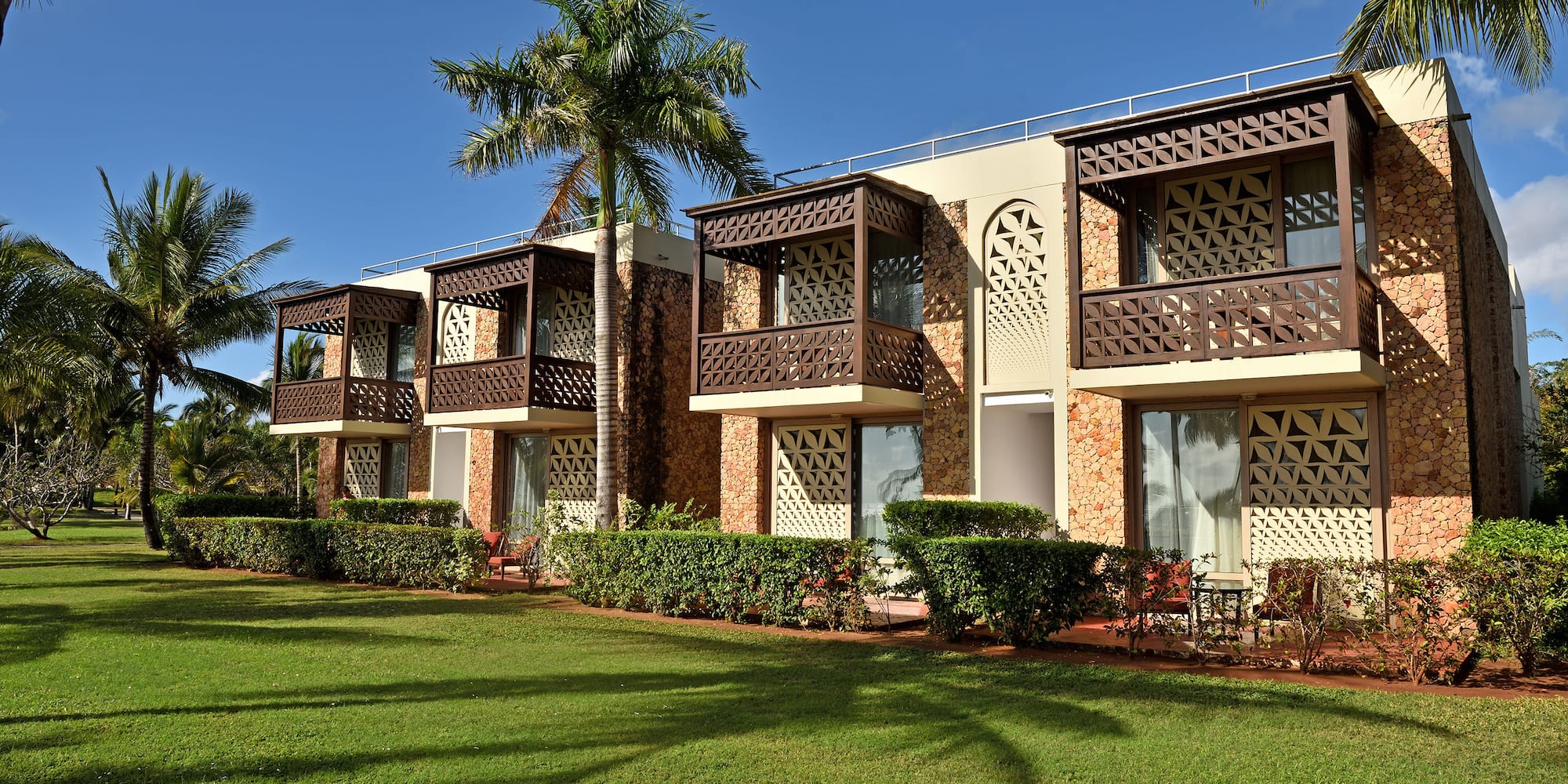 a building with balconies and palm trees
