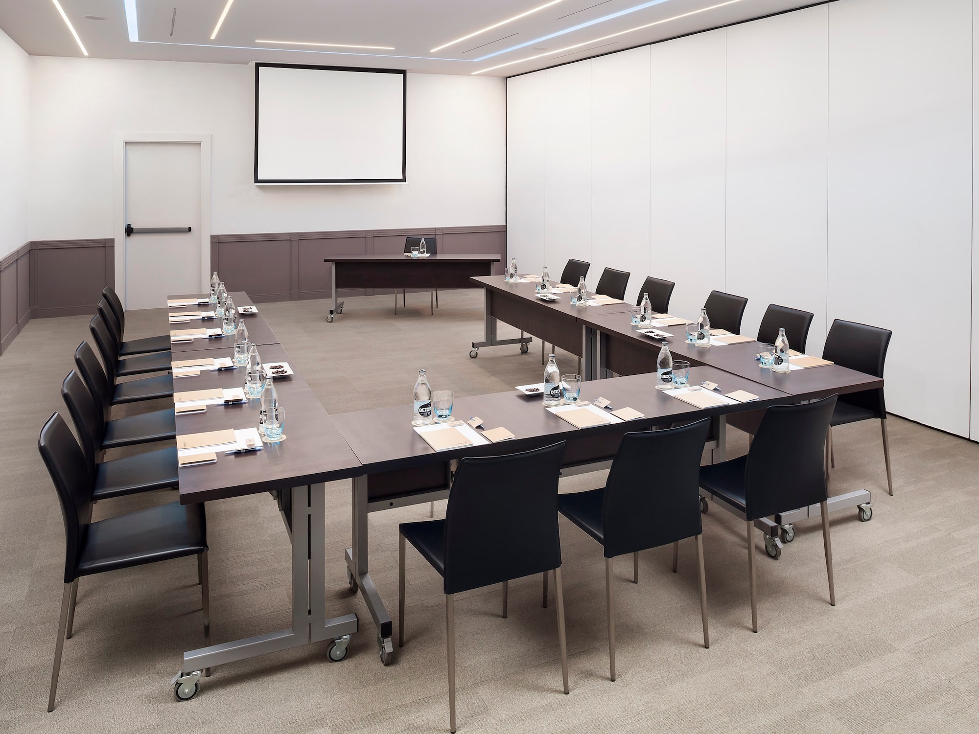 a conference room with tables and chairs
