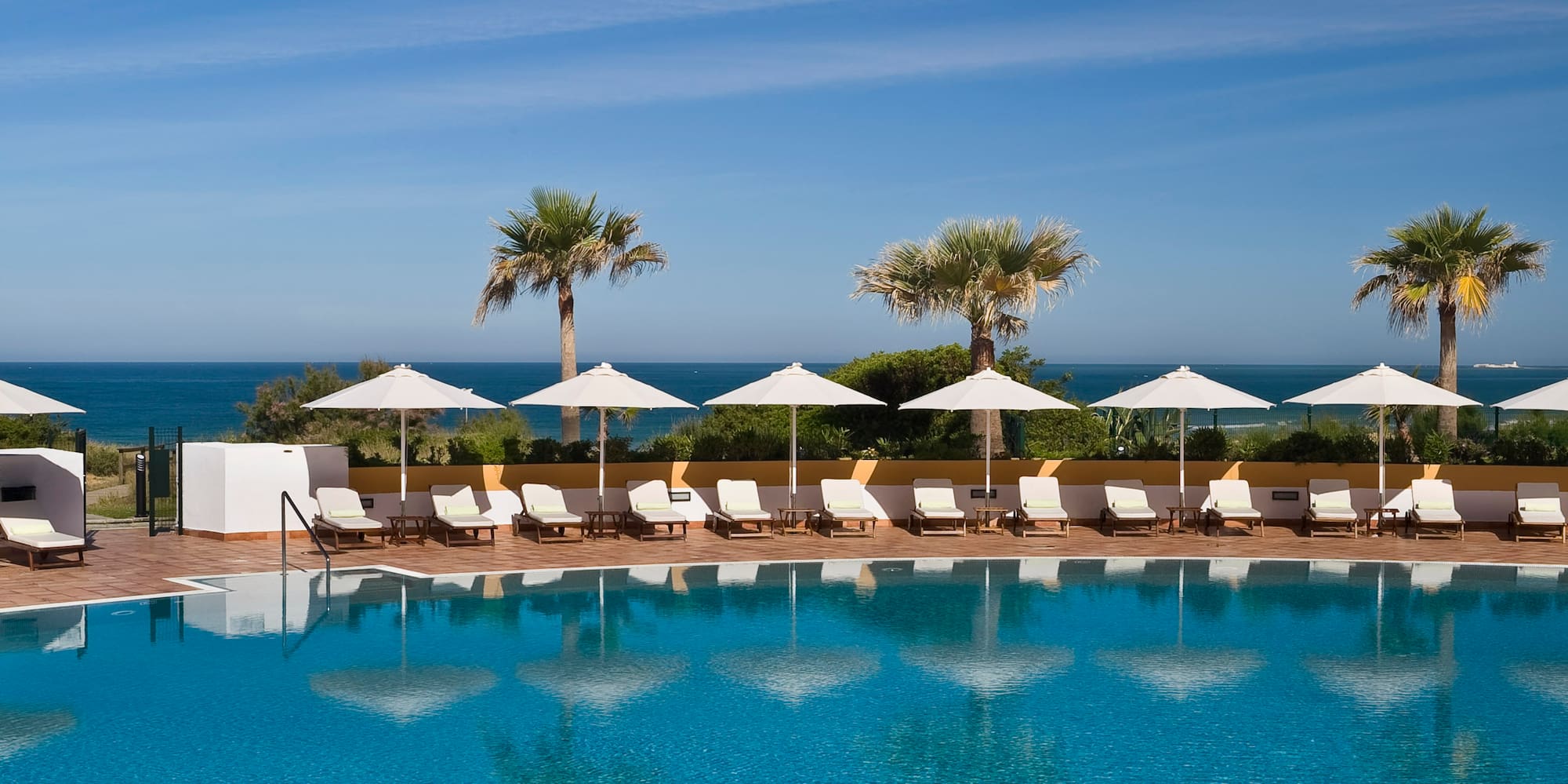 a pool with chairs and umbrellas