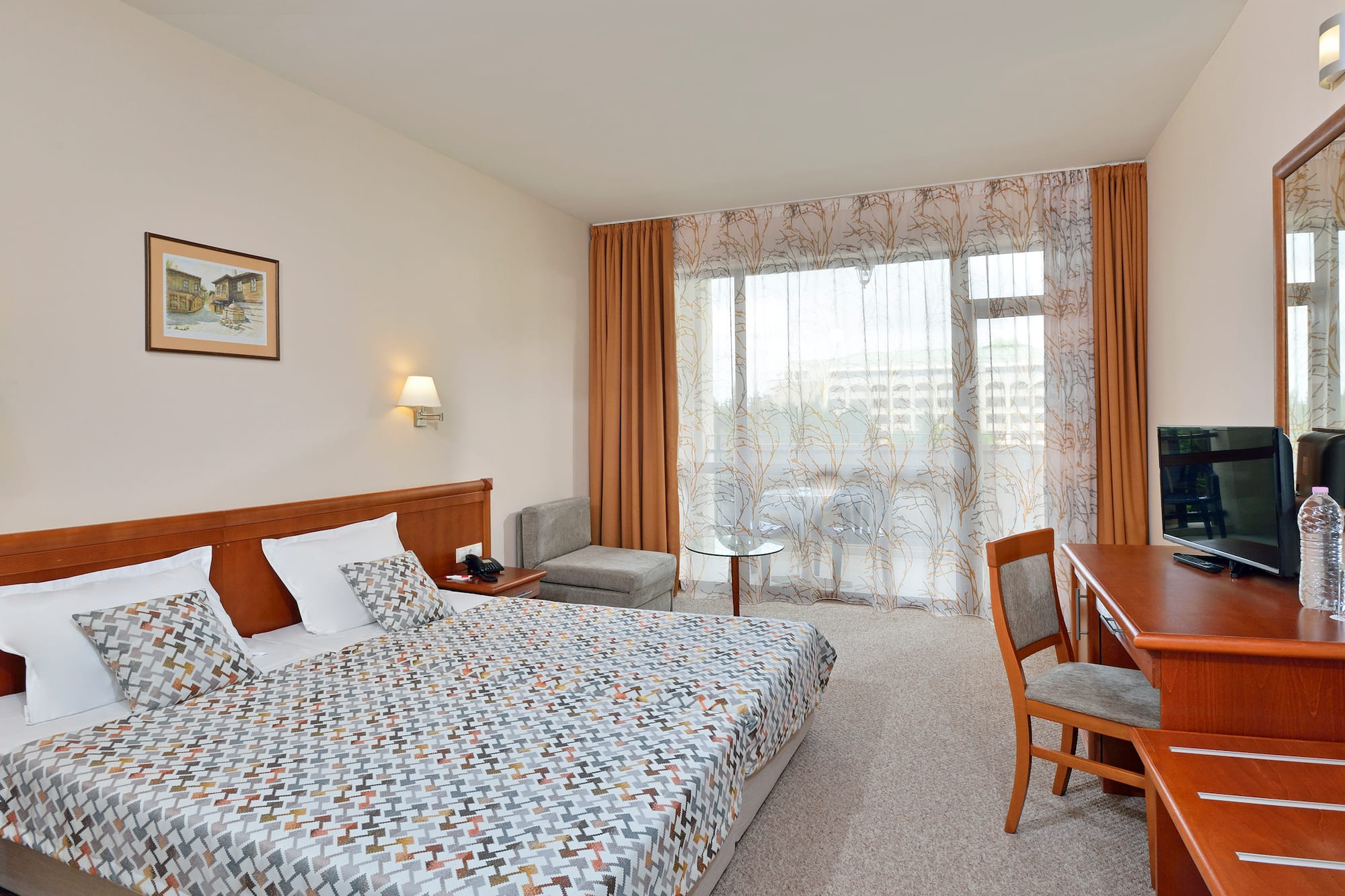 a bedroom with a bed and a desk