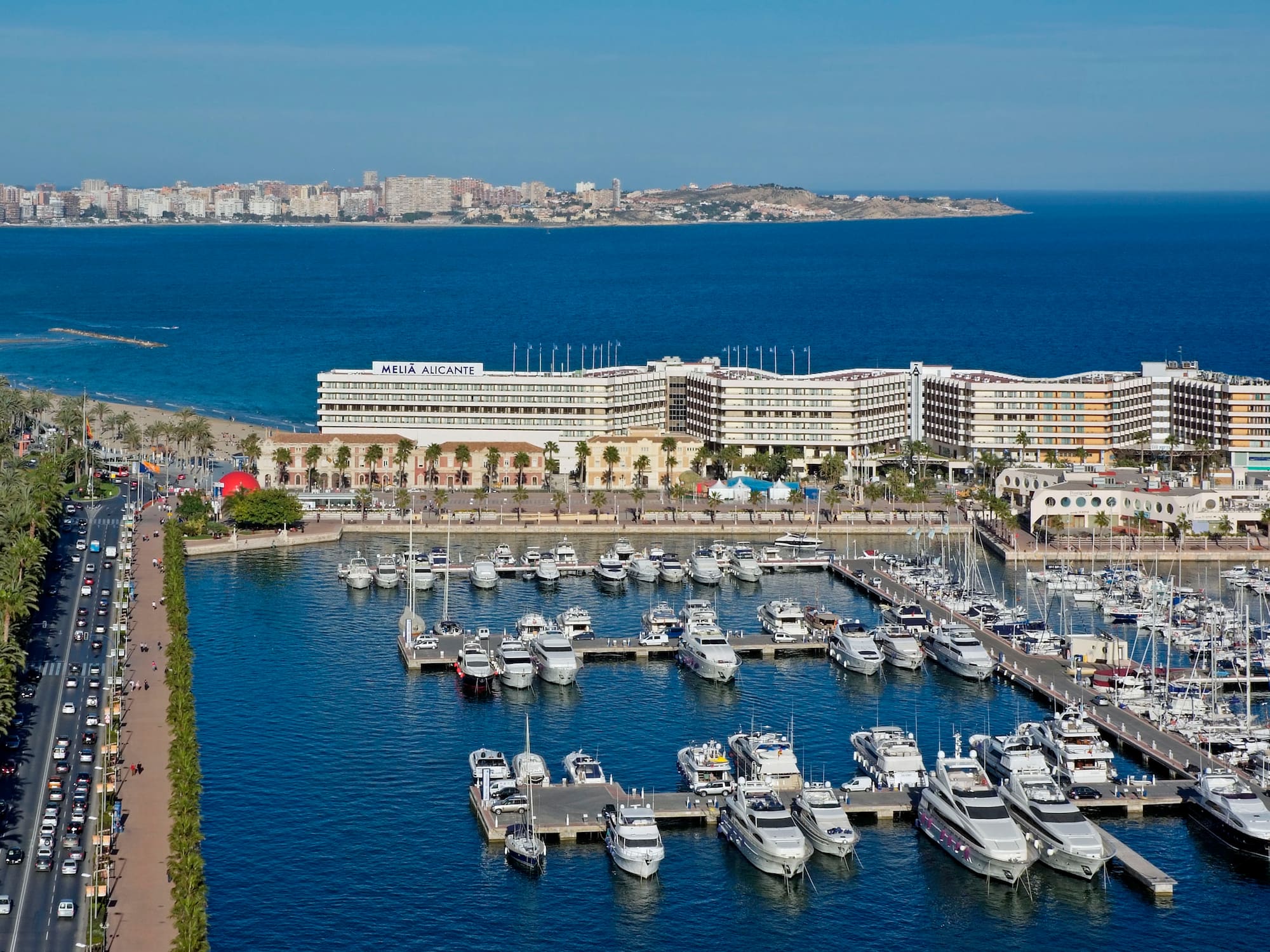 a marina with many boats and buildings in the background