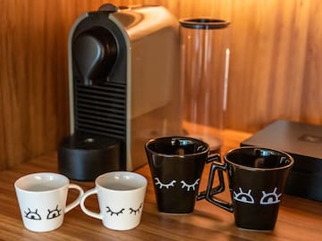 a group of coffee cups with faces on them