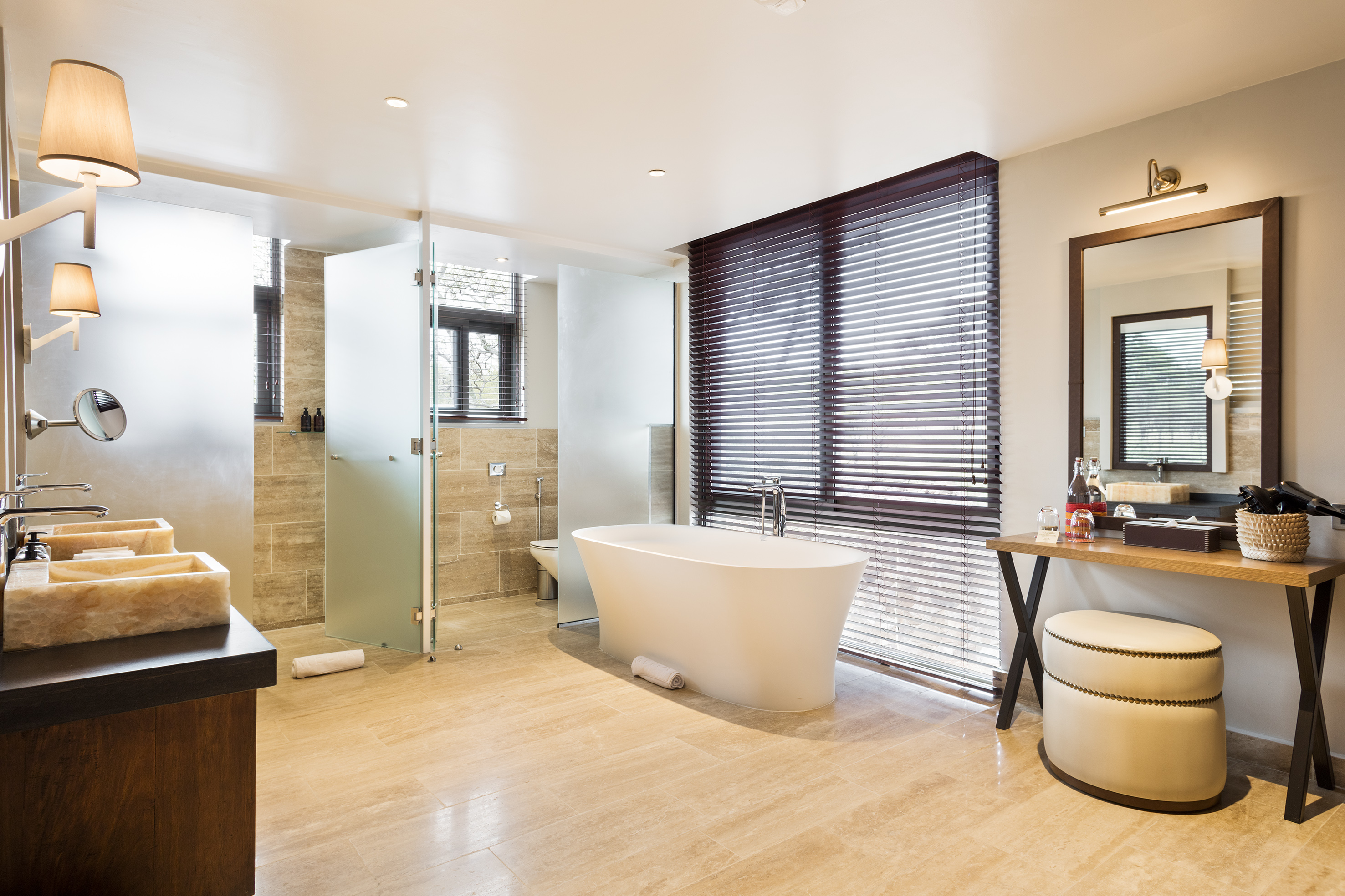 Luxury modern bathroom with freestanding tub, double vanity, and glass shower.