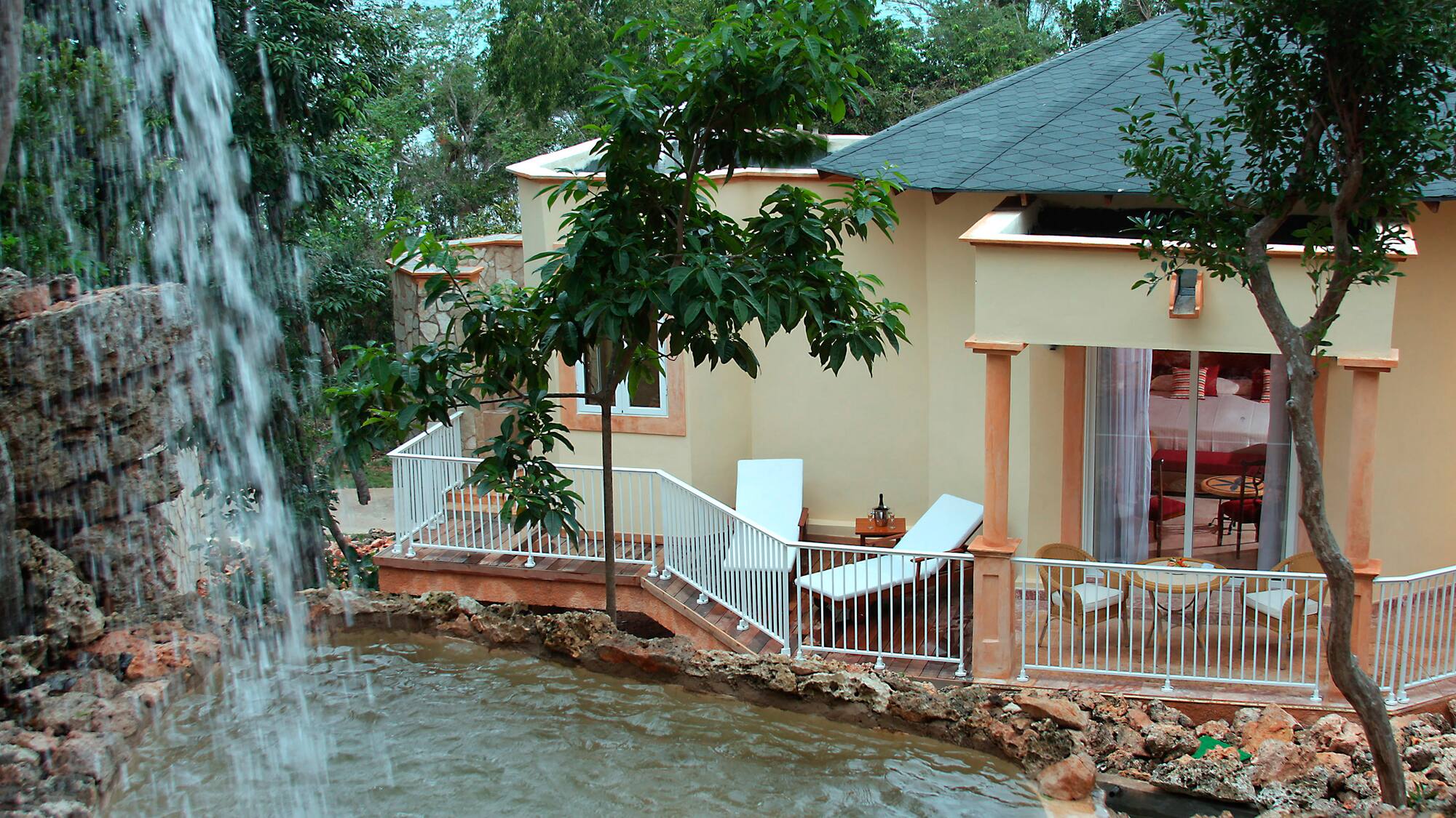 a house with a waterfall in the background