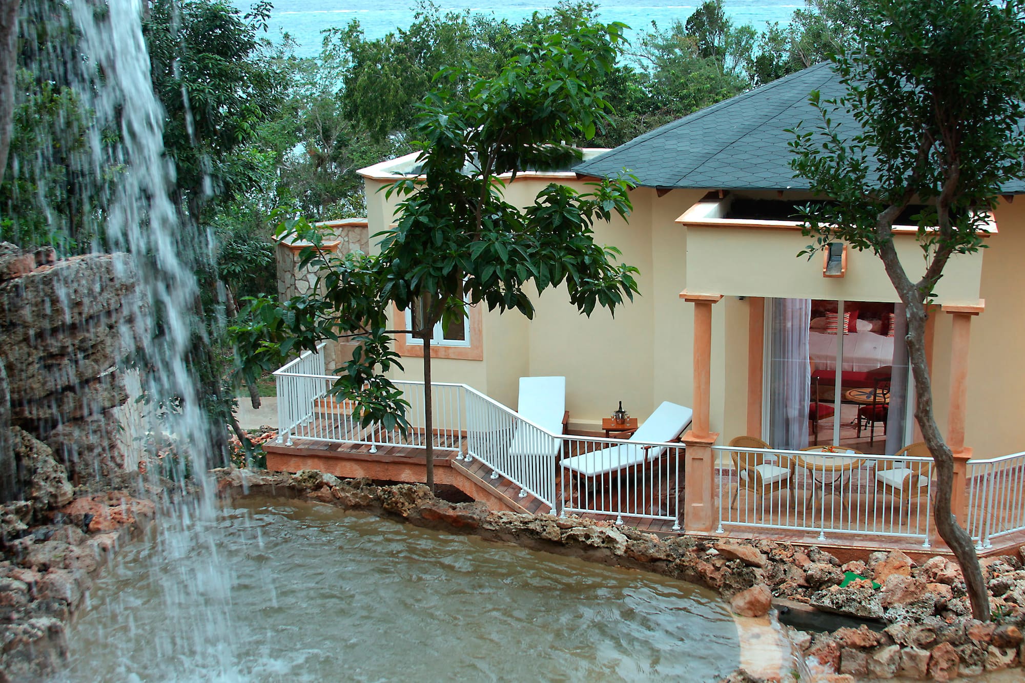 a house with a waterfall in the background