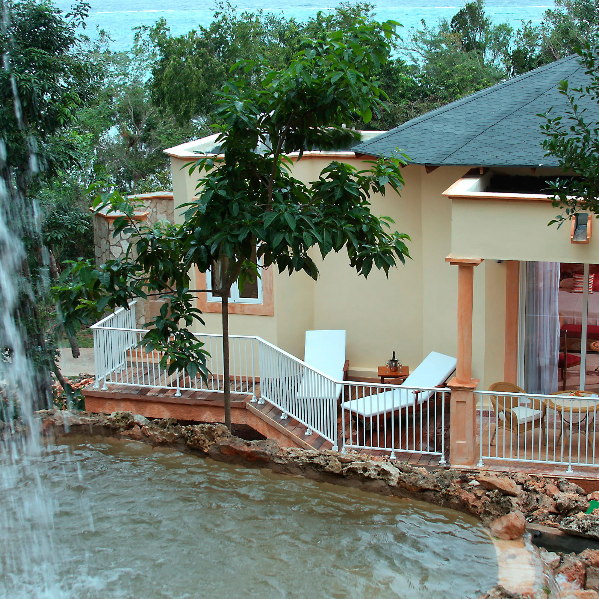a house with a waterfall in the background