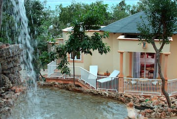 a house with a waterfall in the background