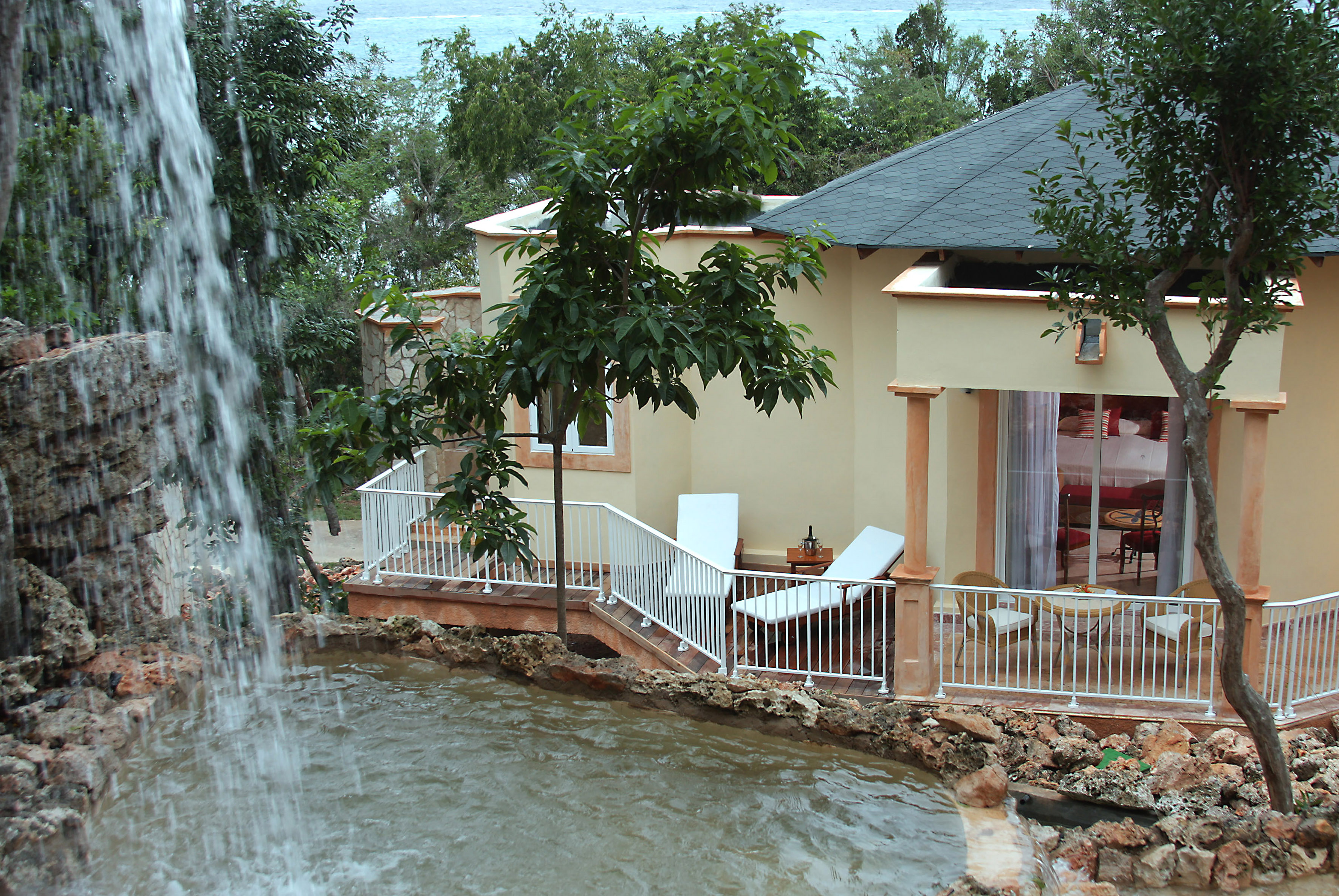 a house with a waterfall in the background