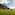 a group of people doing yoga on a grassy field