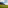 Outdoor group yoga on lush green field overlooking mountains and ocean.
