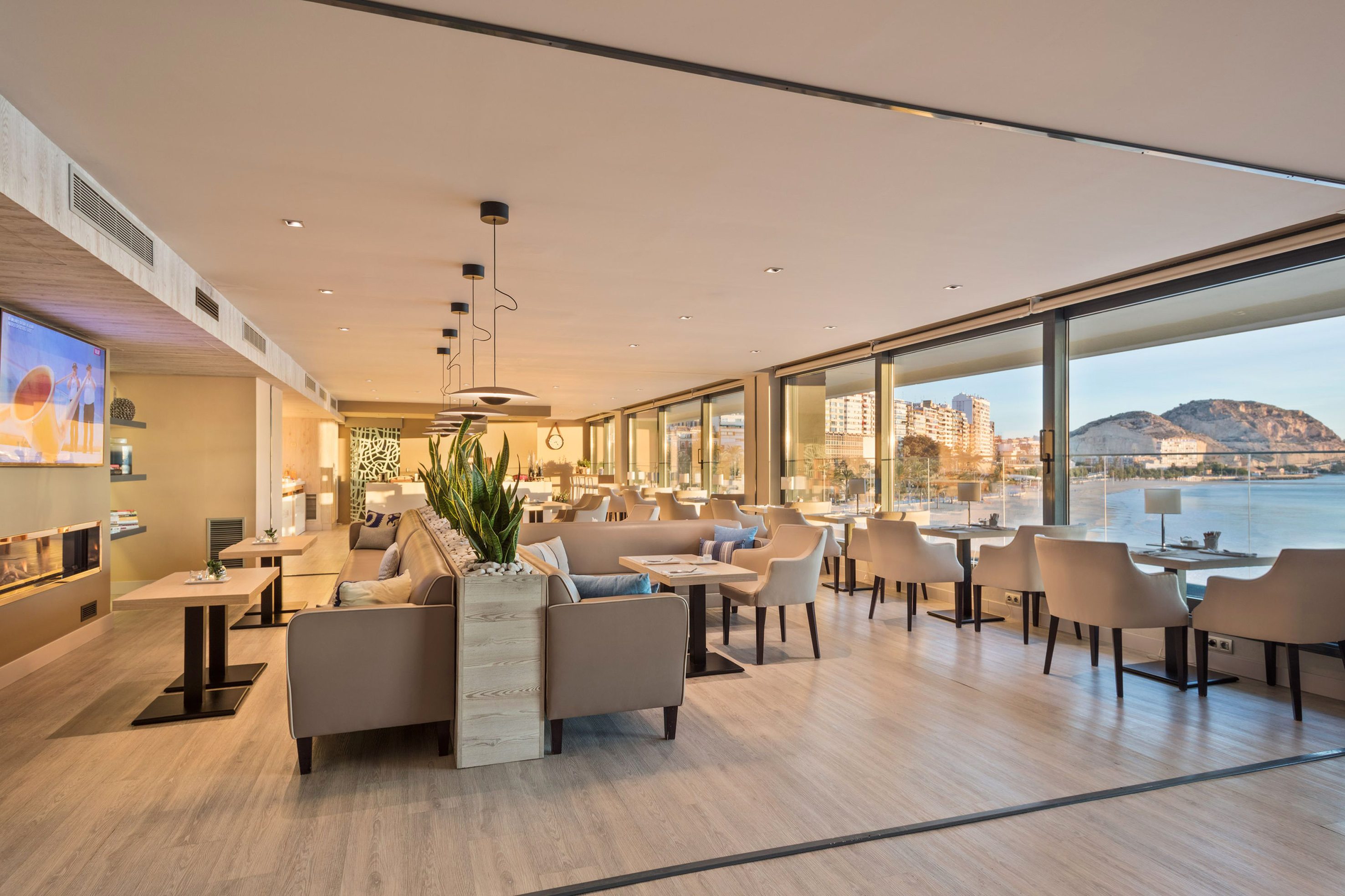 Bright, modern hotel lounge overlooking beach and ocean view.