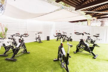 a group of exercise bikes on a green field