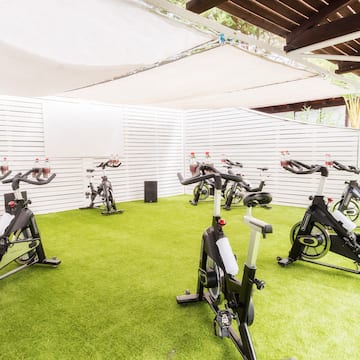 a group of exercise bikes on a green field