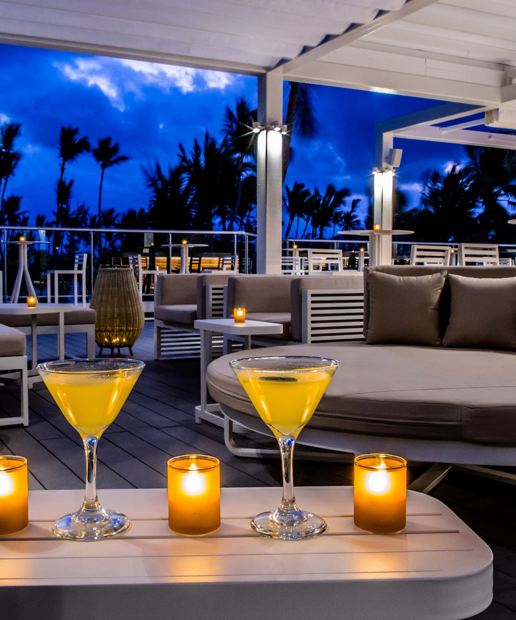 a table with drinks and candles on it