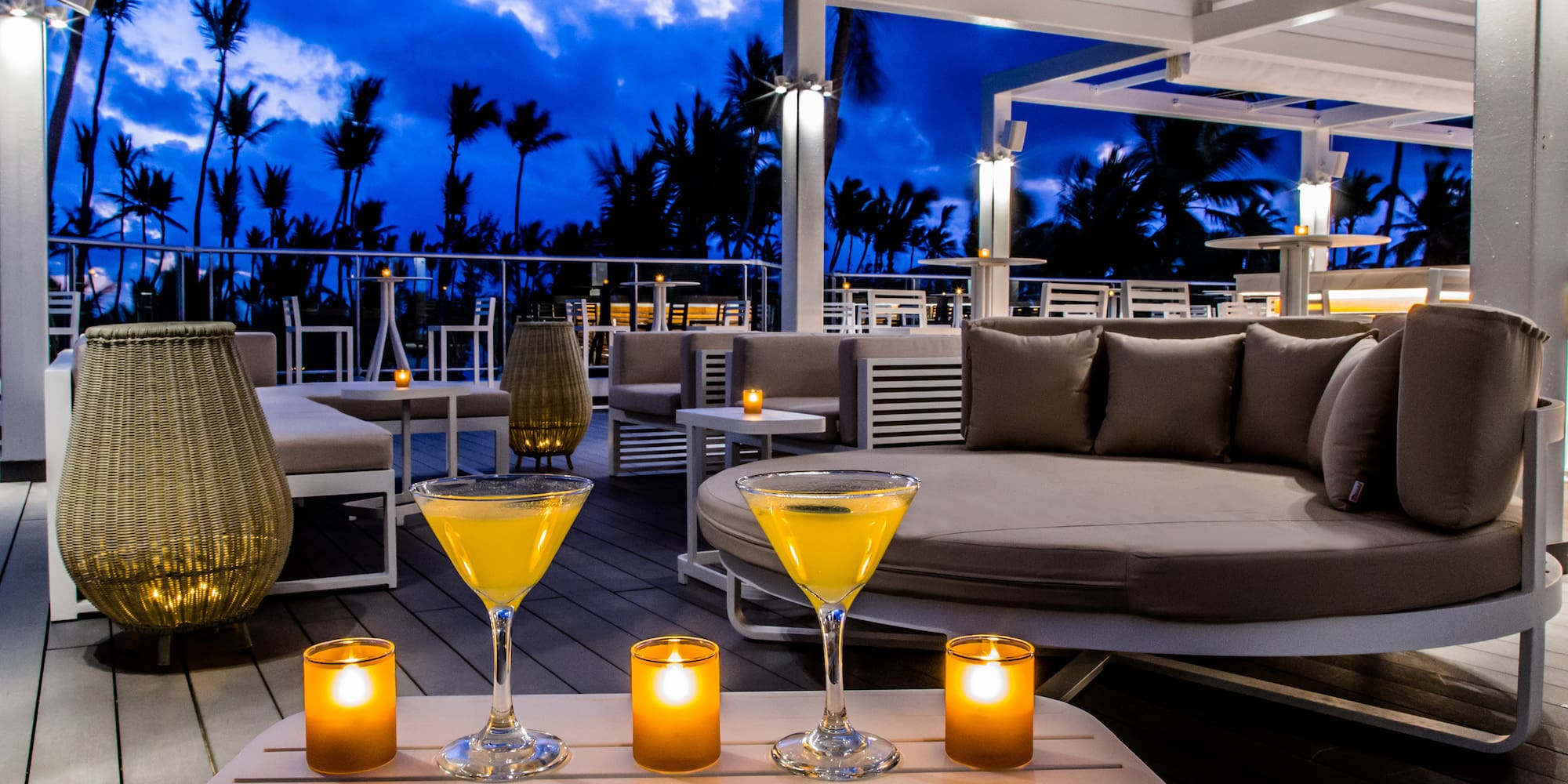 a table with drinks and candles on it