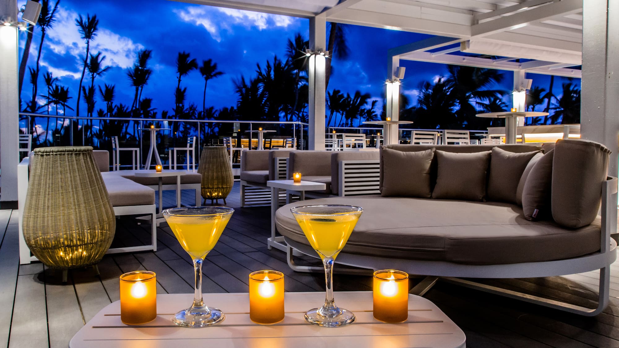 a table with drinks and candles on it