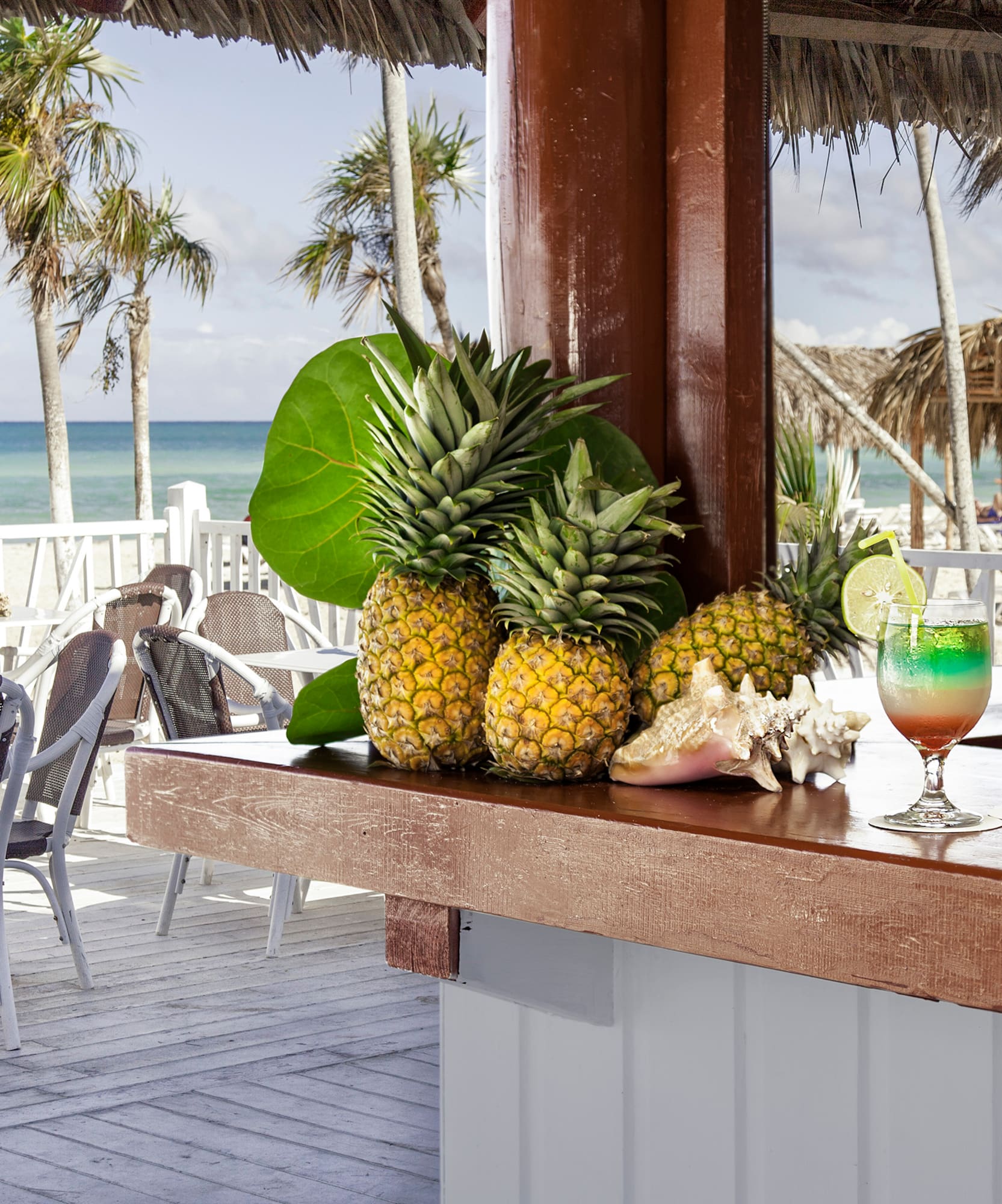 a bar with a drink and pineapples on it