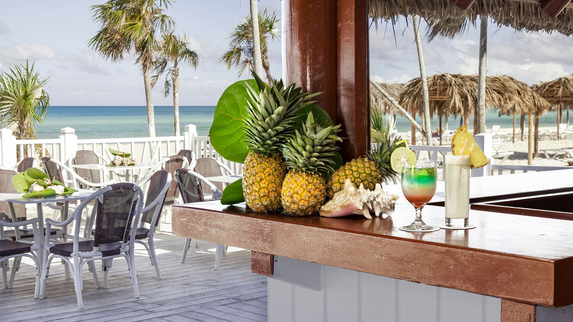 a bar with a drink and pineapples on it