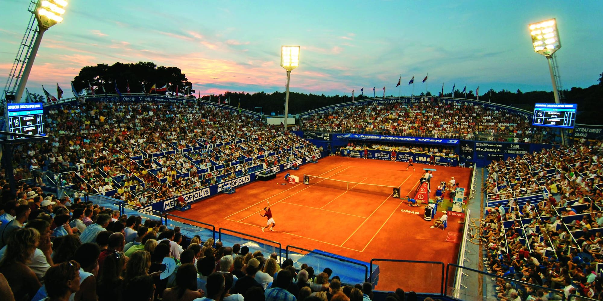 a tennis court with people watching