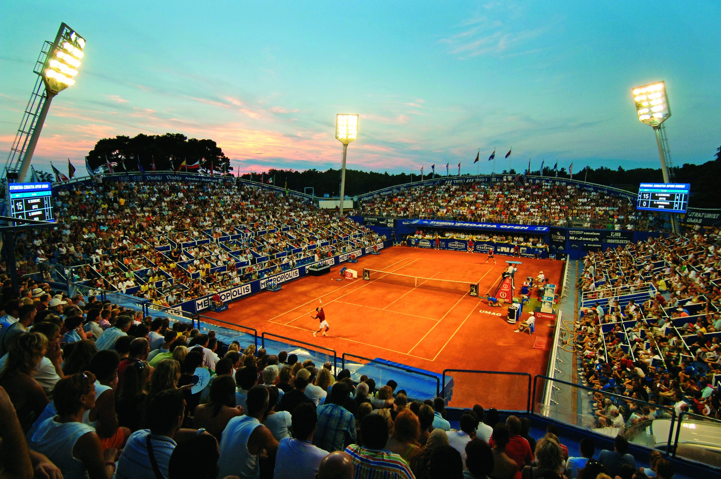 a tennis court with people watching