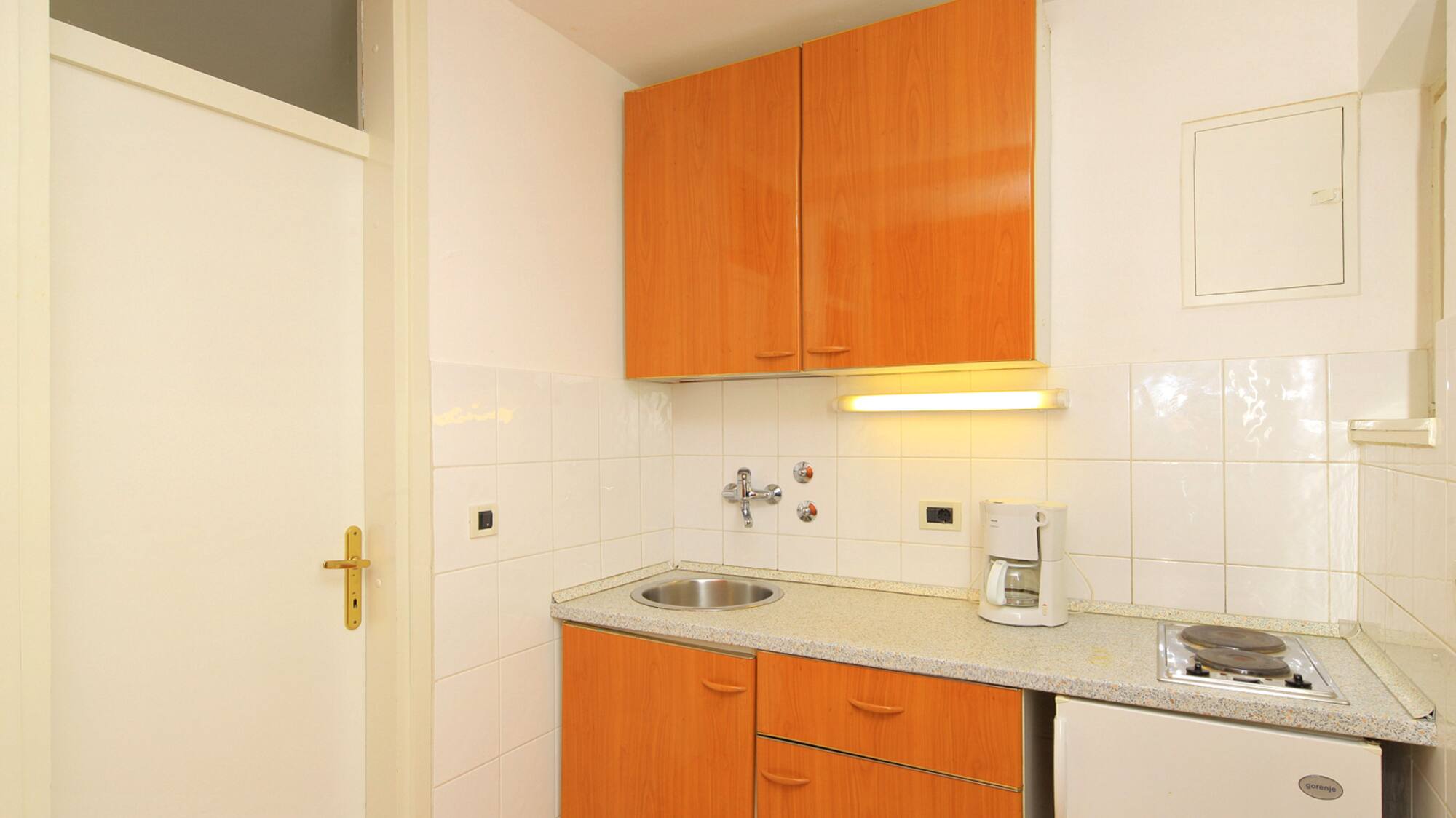 a kitchen with a sink and a refrigerator