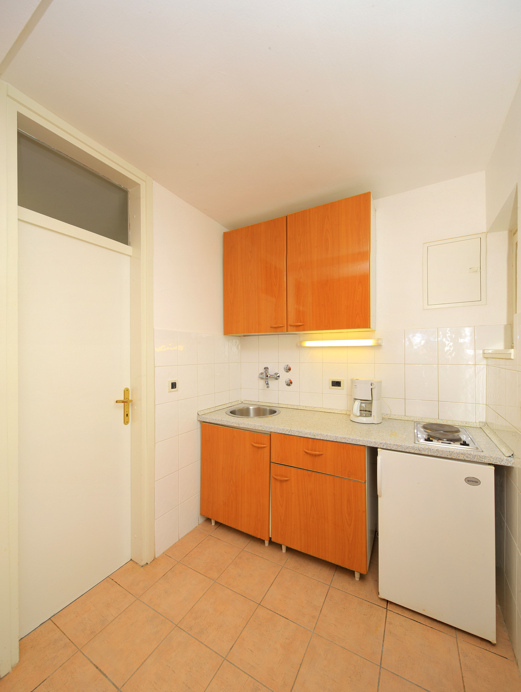 a kitchen with a sink and a refrigerator