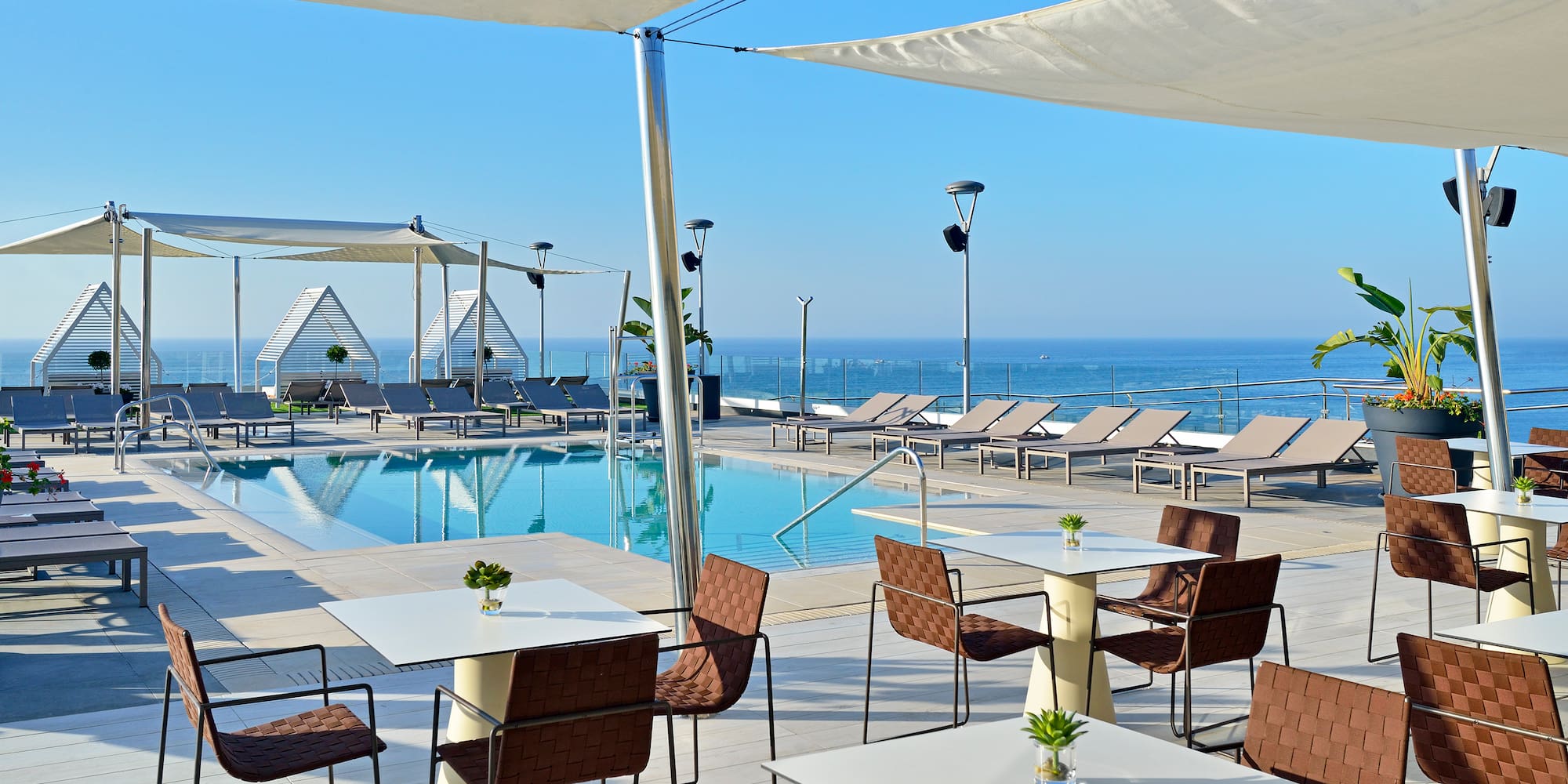 a pool with tables and chairs
