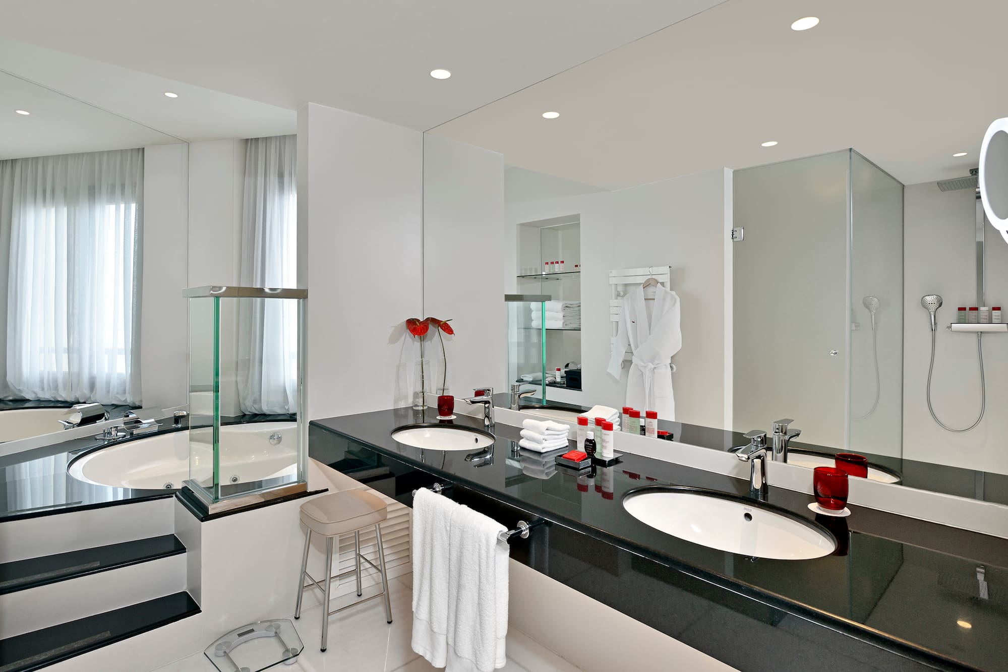 a bathroom with a black countertop and white tile floor