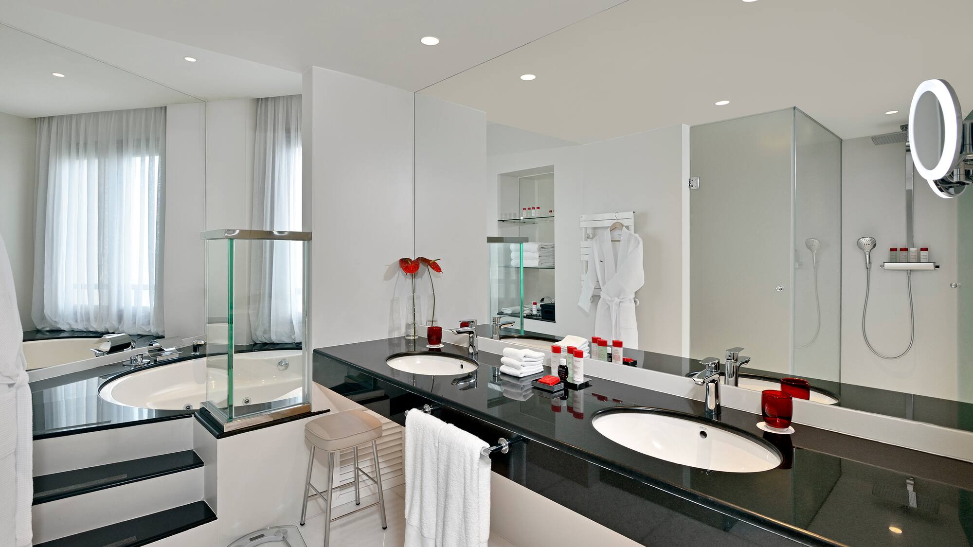a bathroom with a black countertop and white tile floor