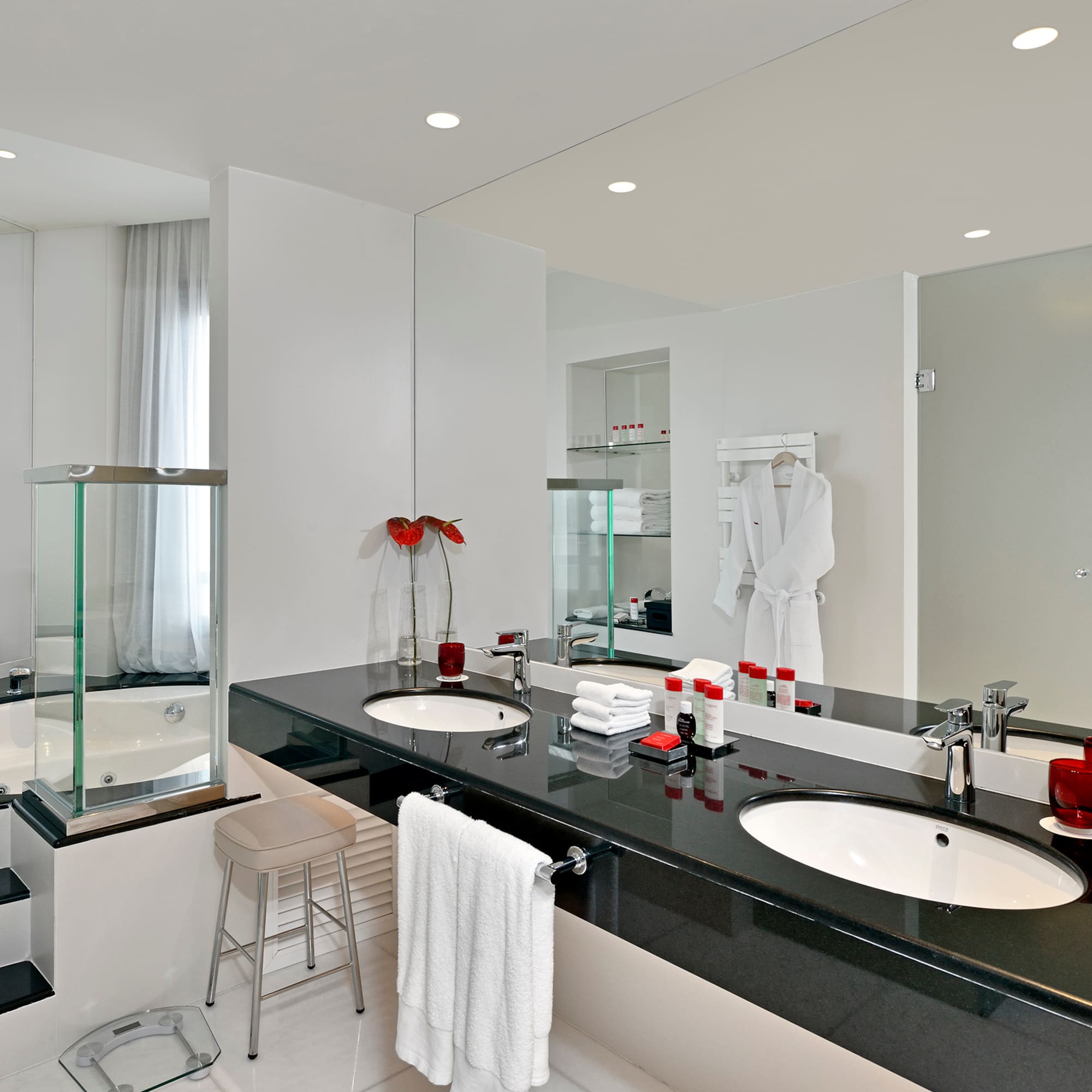 a bathroom with a black countertop and white tile floor