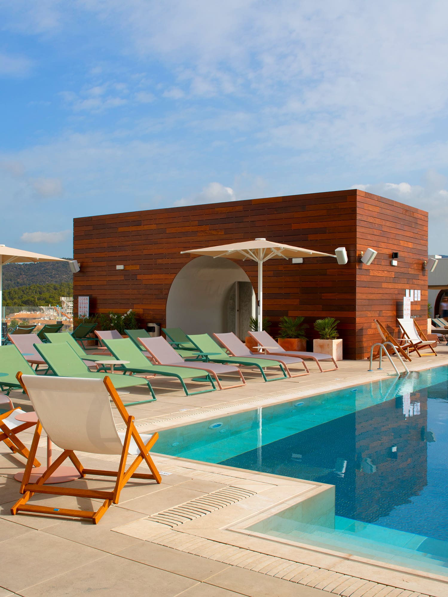 a pool with chairs and umbrellas