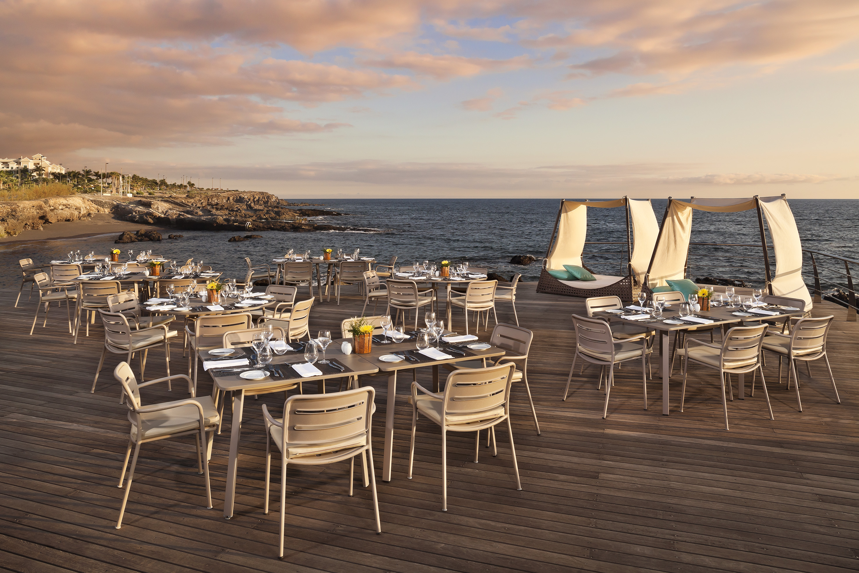 a table set up on a deck overlooking a body of water