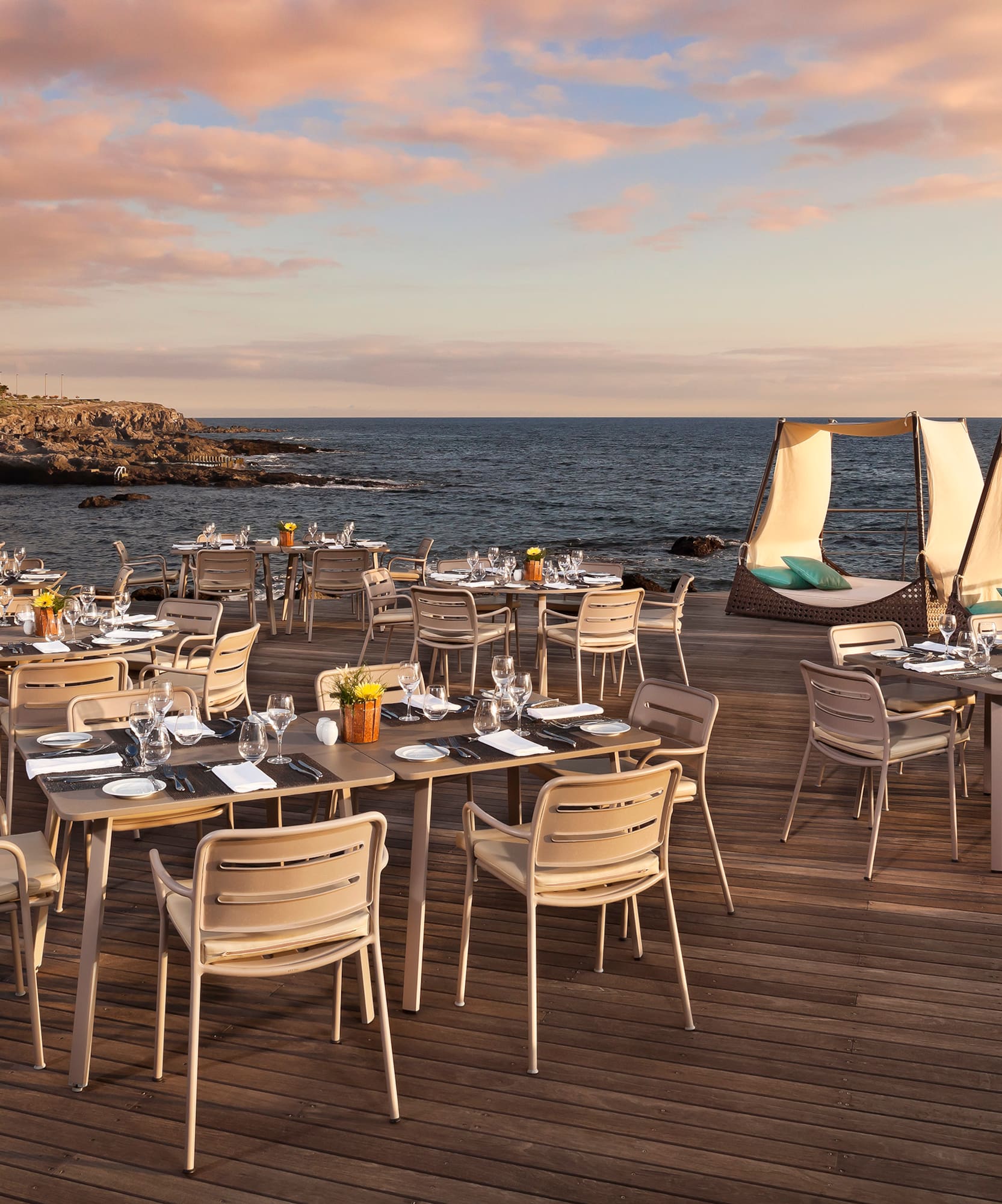 a table set up on a deck overlooking a body of water