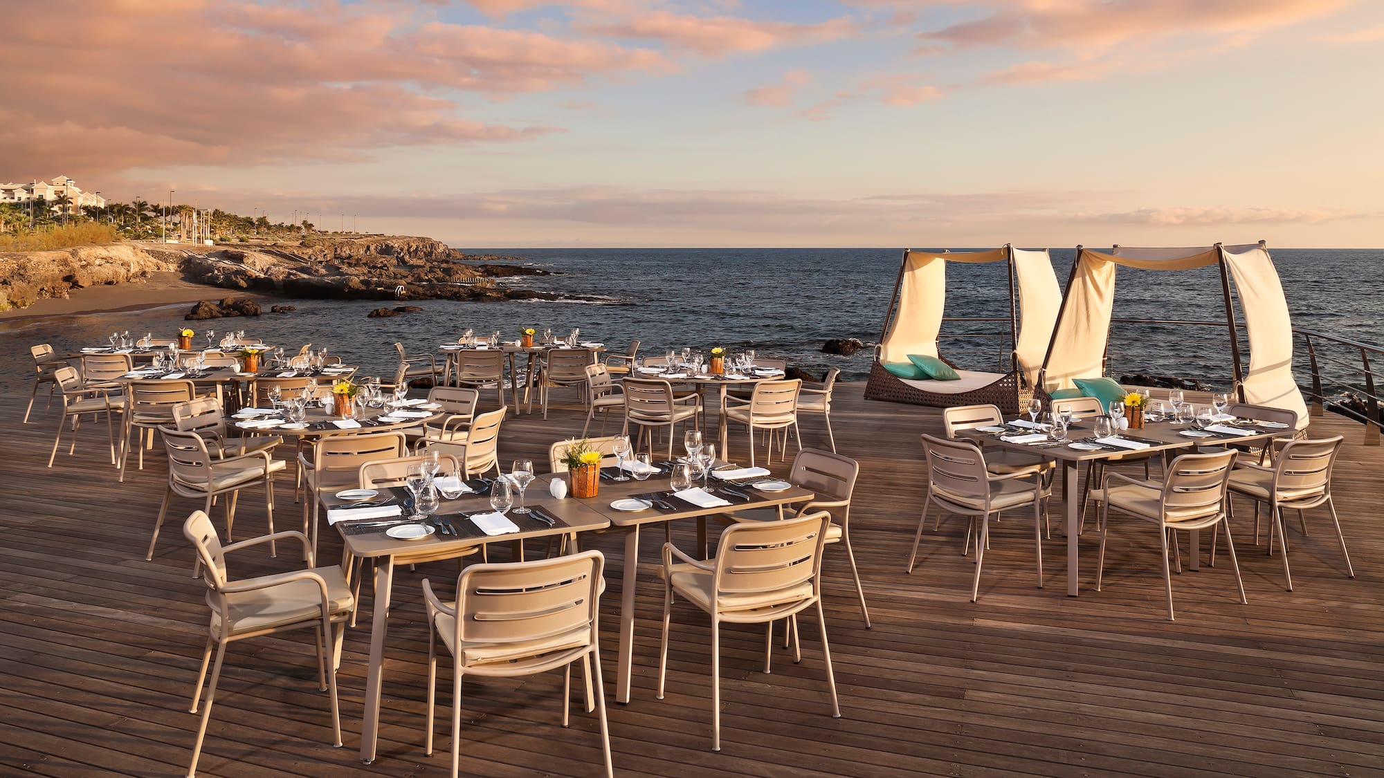 a table set up on a deck overlooking a body of water