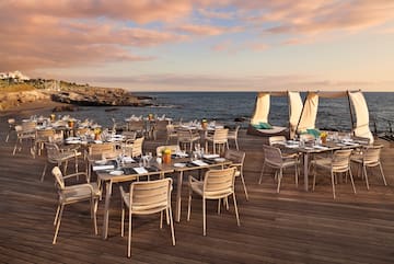 a table set up on a deck overlooking a body of water