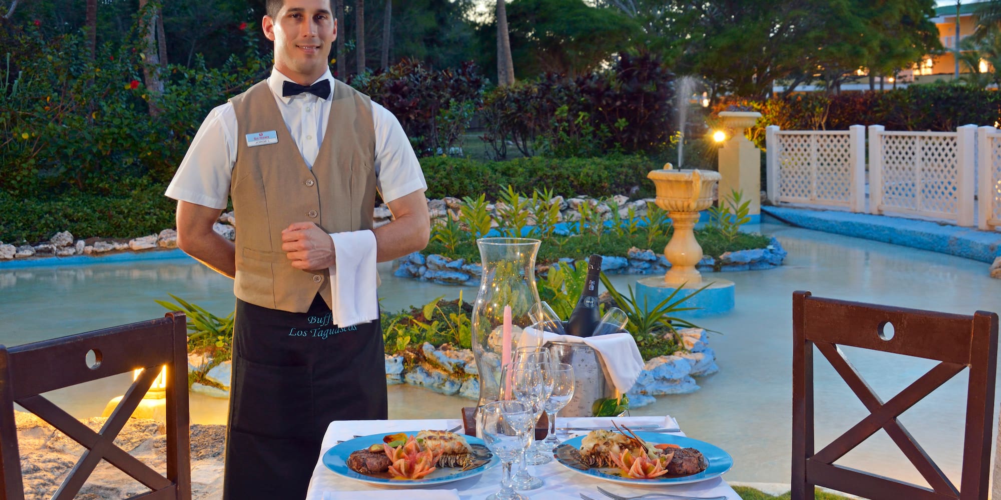 a man standing in front of a table with food on it