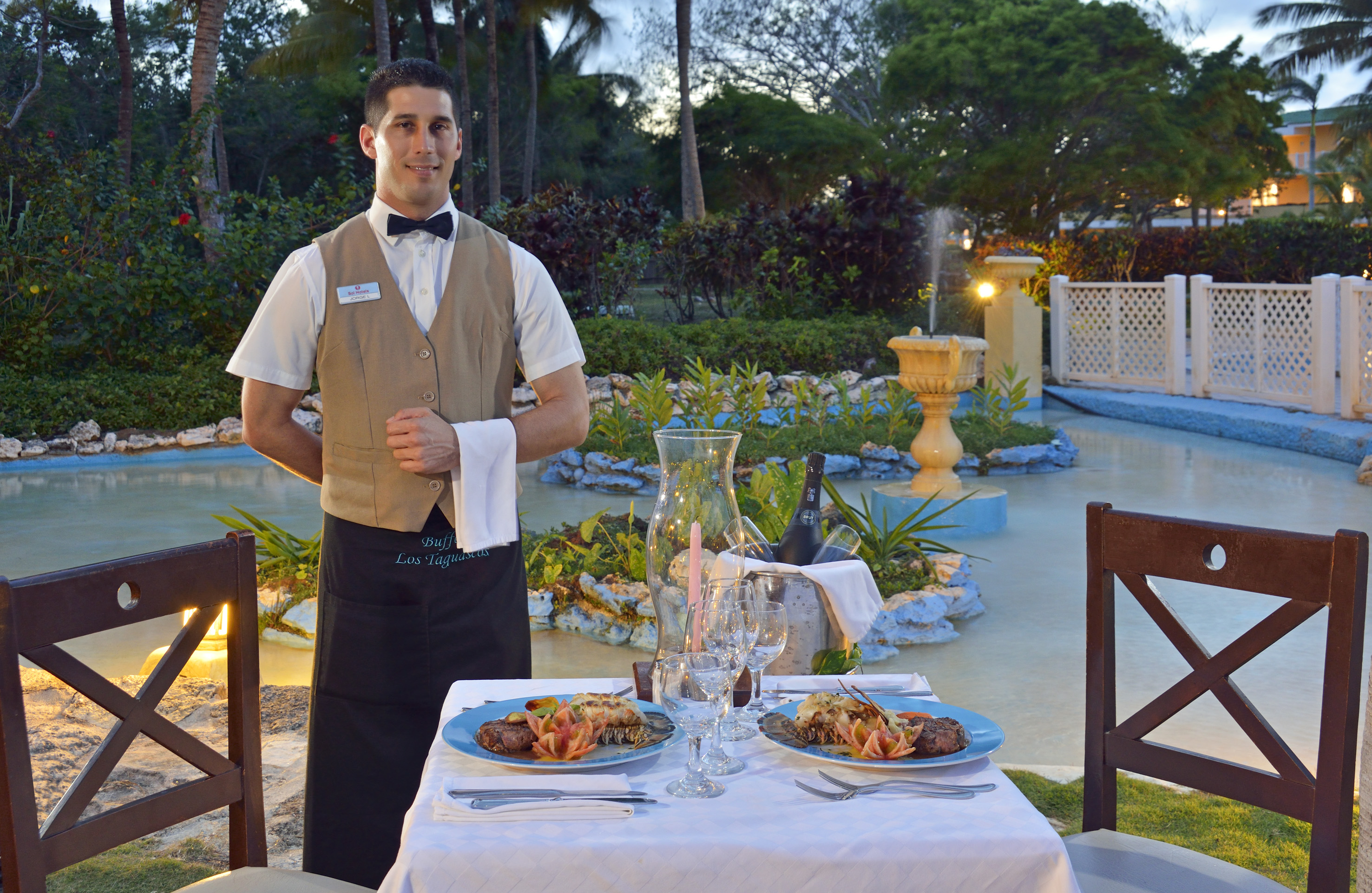 a man standing in front of a table with food on it