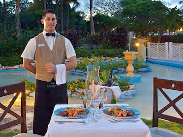 a man standing in front of a table with food on it