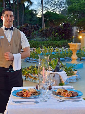 a man standing in front of a table with food on it