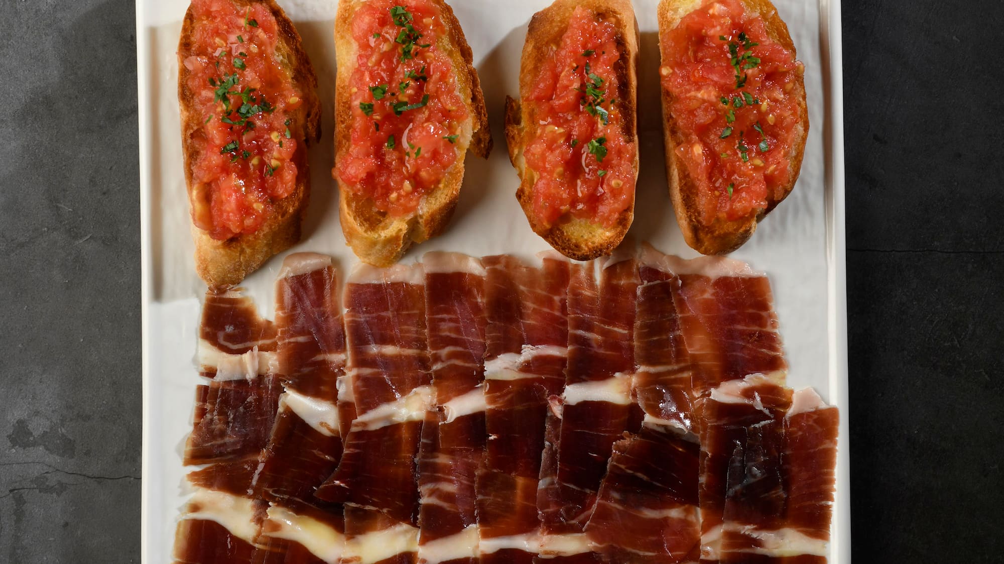 a plate of food next to tomatoes