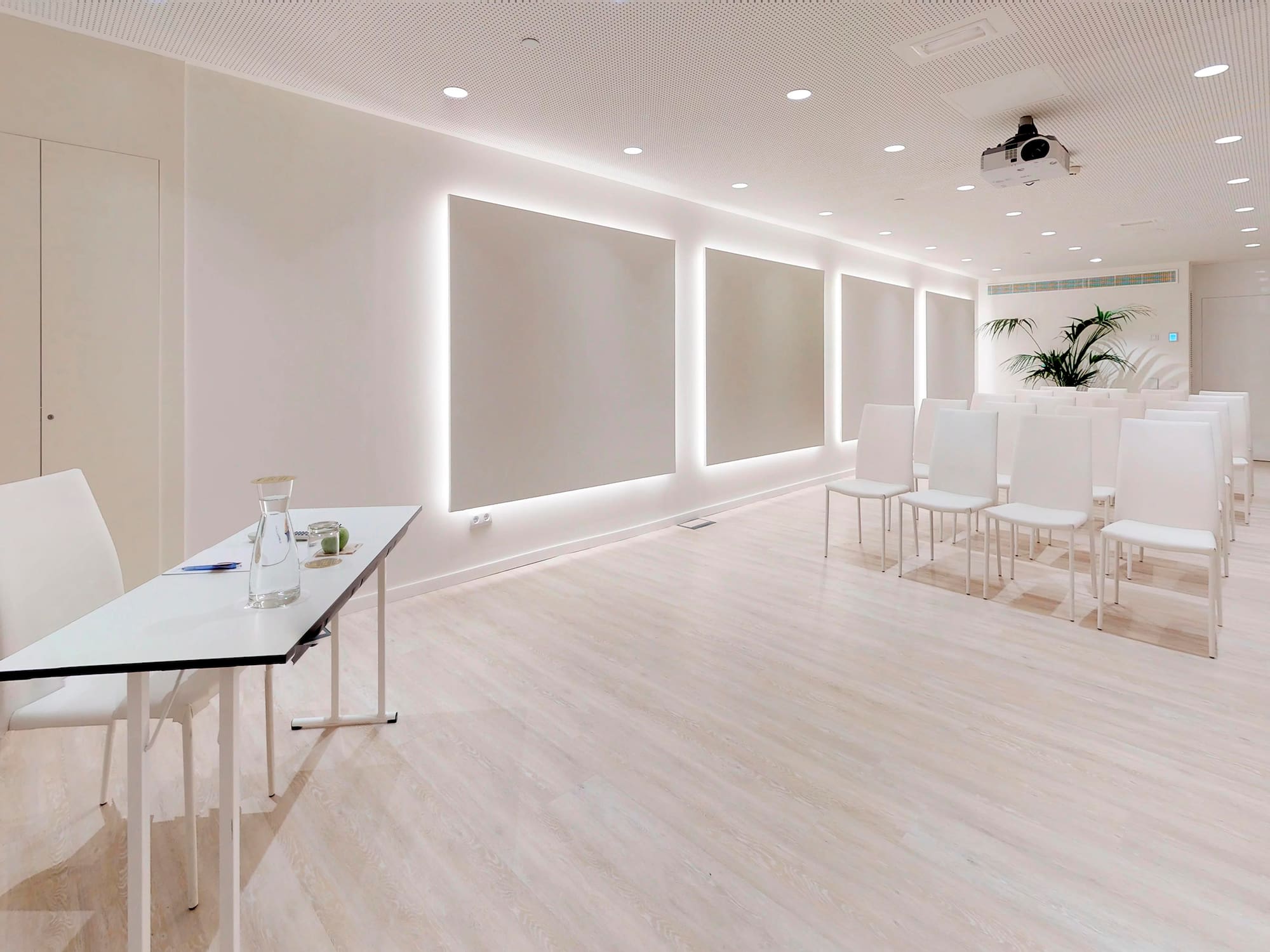 a room with white walls and white chairs